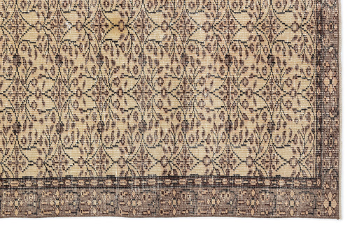 Load image 1 in gallery view. Beige and dark brown vintage-style rug with a repeating floral lattice pattern and a wide decorative border.