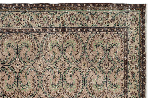 Load image 1 in gallery view. Taupe, brown, and sage green vintage-style rug with a repeating floral vine pattern and a decorative border.