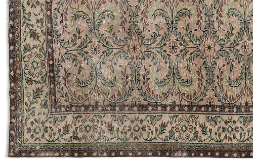Load image 1 in gallery view. Distressed taupe and green rug with a traditional floral vine pattern and a dark brown geometric border.