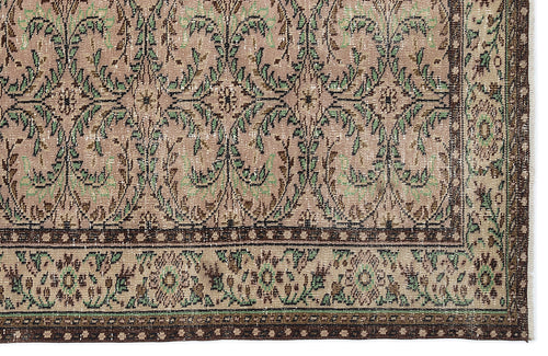 Load image 1 in gallery view. Distressed beige rug with a repeating green and brown floral vine pattern and a decorative border.