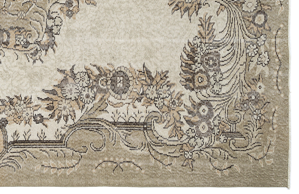 Beige and taupe rug with a distressed traditional floral medallion pattern and ornate border.