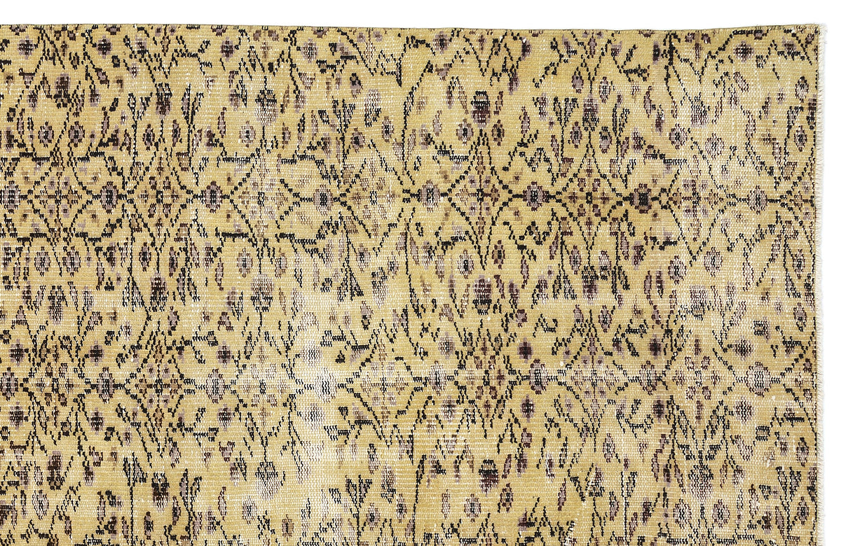 Mustard yellow vintage-style rug with a distressed black and grey floral trellis pattern.