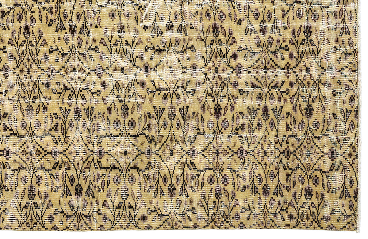 Mustard yellow rug with a distressed, repeating dark brown and grey floral lattice pattern.