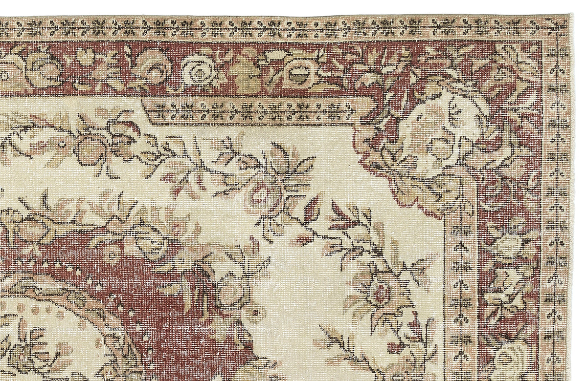 Cream and terracotta traditional rug with a distressed floral medallion pattern and ornate border.