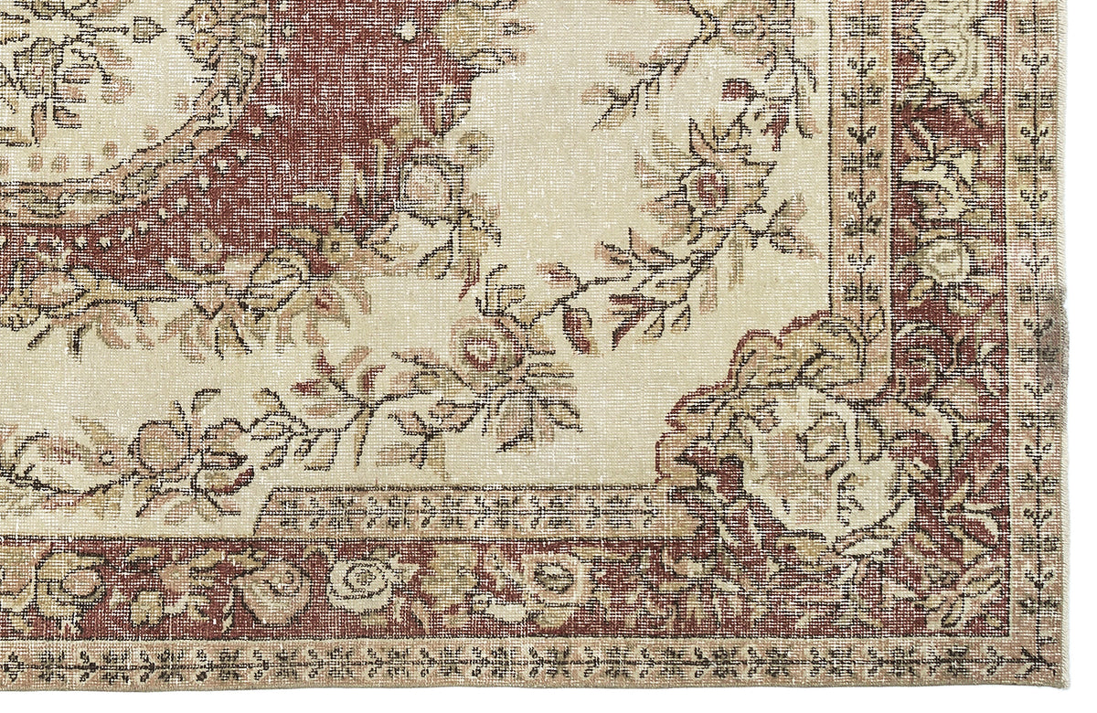 Distressed cream and terracotta rug with a traditional floral medallion pattern and ornate border.