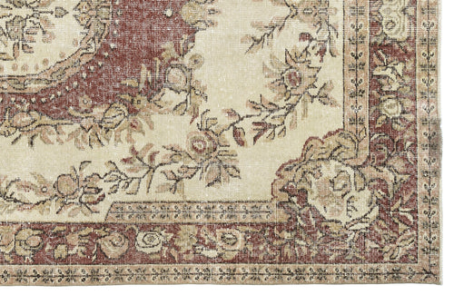 Load image 1 in gallery view. Distressed cream and terracotta rug with a traditional floral medallion pattern and ornate border.
