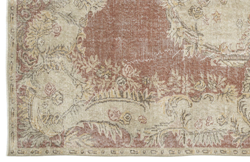 Load image 1 in gallery view. Distressed terracotta and beige rug with a traditional floral medallion pattern and a woven border.