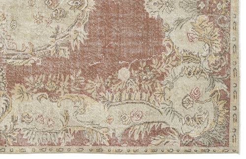 Load image 1 in gallery view. Distressed terracotta and beige rug with a traditional floral medallion pattern and a decorative border.