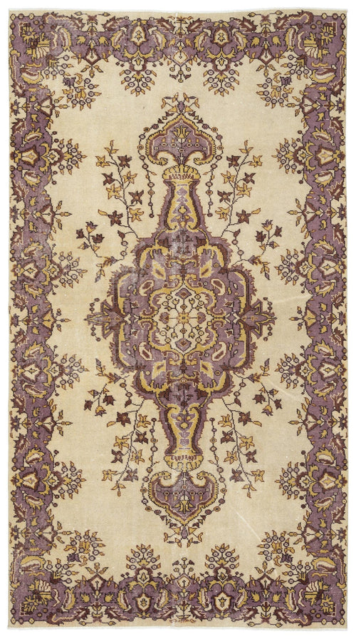 Load image 1 in gallery view. Beige rug with a central purple and gold floral medallion and a matching ornate floral border.
