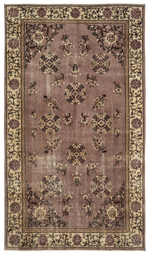 Load image 1 in gallery view. Mauve vintage-style rug with dark brown circular medallions, floral motifs, and a geometric border on a white background.