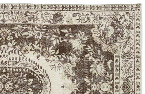 Load image 1 in gallery view. Dark brown and cream traditional rug with a distressed floral medallion pattern and ornate border.