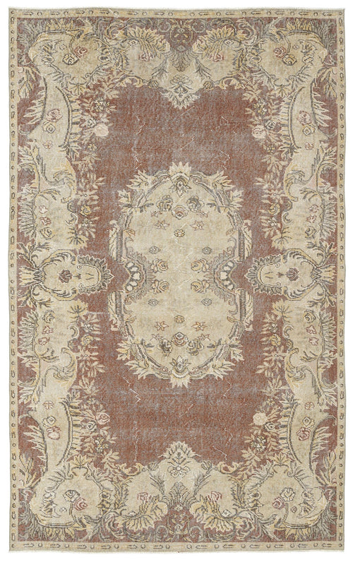 Load image 1 in gallery view. Distressed brown and beige traditional rug with a central floral medallion and ornate botanical border.