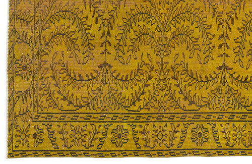 Load image 1 in gallery view. Mustard yellow rug with a dark brown botanical vine pattern and a geometric border.