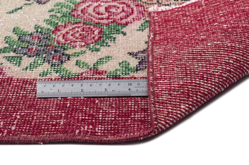 Load image 1 in gallery view. Cream rug with red floral pattern and a folded corner showing the red woven backing, measured by a metal ruler.