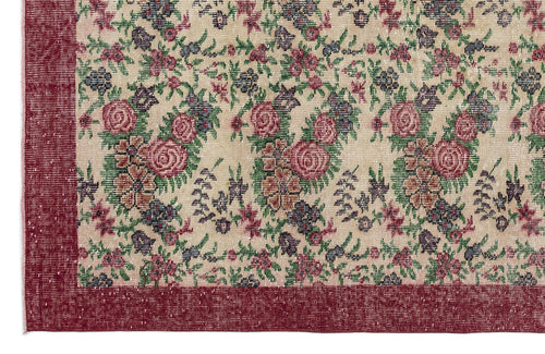 Load image 1 in gallery view. Beige rug with a floral pattern in red, green, and purple, featuring a solid red border.