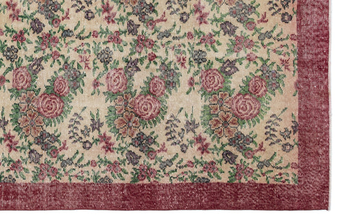 Load image 1 in gallery view. Beige rug with a floral pattern in red, green, and dark grey, featuring a solid red border.