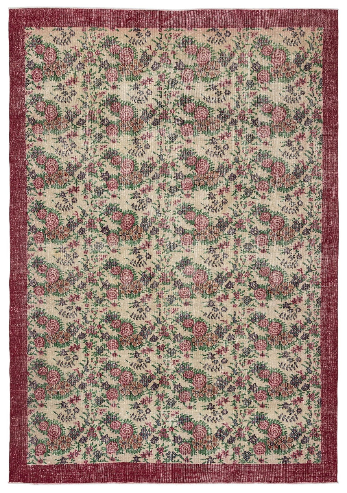 Beige rug with a red border and a repeating floral pattern in shades of red, green, and dark purple.