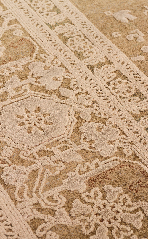 Load image 1 in gallery view. Tan and cream rug with a raised, tufted traditional floral medallion pattern and a decorative border.