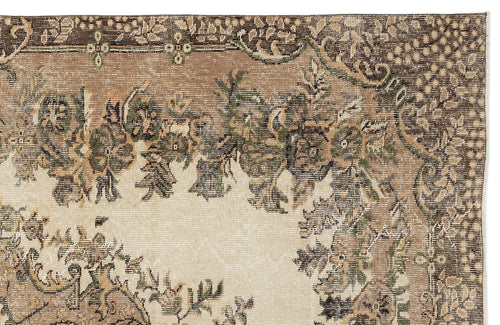Load image 1 in gallery view. Beige, brown, and olive green traditional rug with a distressed floral medallion pattern on a white background.