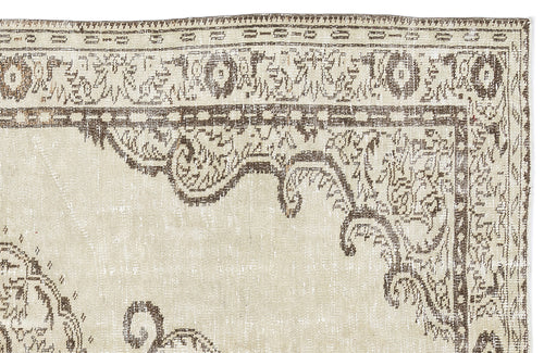 Load image 1 in gallery view. Beige and brown vintage-style rug with a distressed traditional medallion pattern and ornate border.