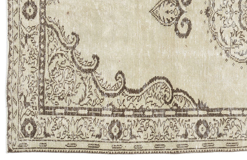 Load image 1 in gallery view. Beige and brown distressed rug with a traditional ornate medallion and border pattern.