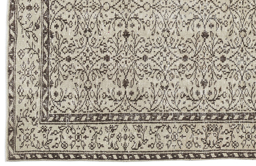 Load image 1 in gallery view. Beige and dark brown rug with a distressed traditional floral medallion pattern and a geometric border.
