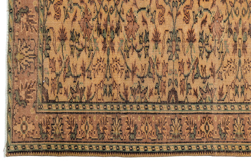 Load image 1 in gallery view. Tan, brown, and sage green traditional rug with a repeating floral motif and a decorative geometric border.