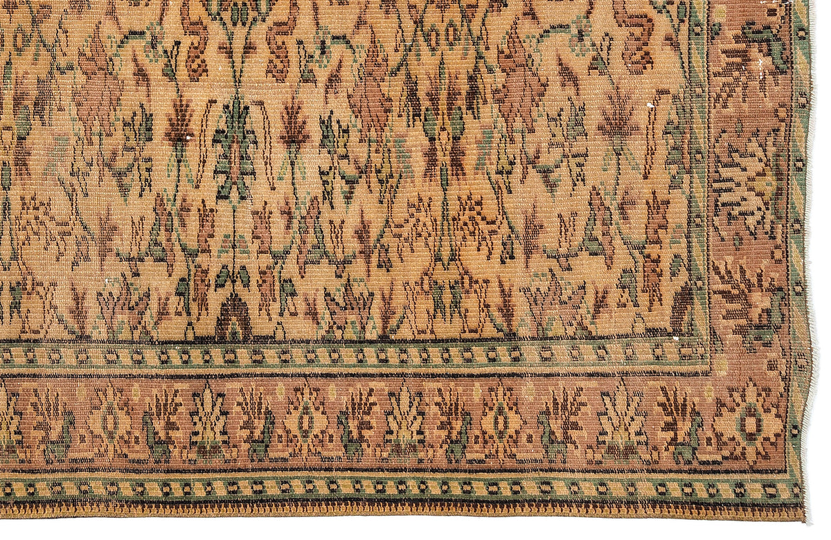 Tan, brown, and sage green traditional rug with a distressed floral motif and a geometric border.