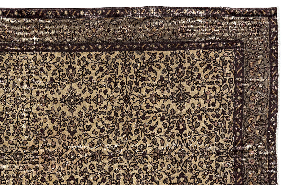 Brown and beige traditional rug with a dense, intricate floral vine pattern and a wide, dark decorative border.