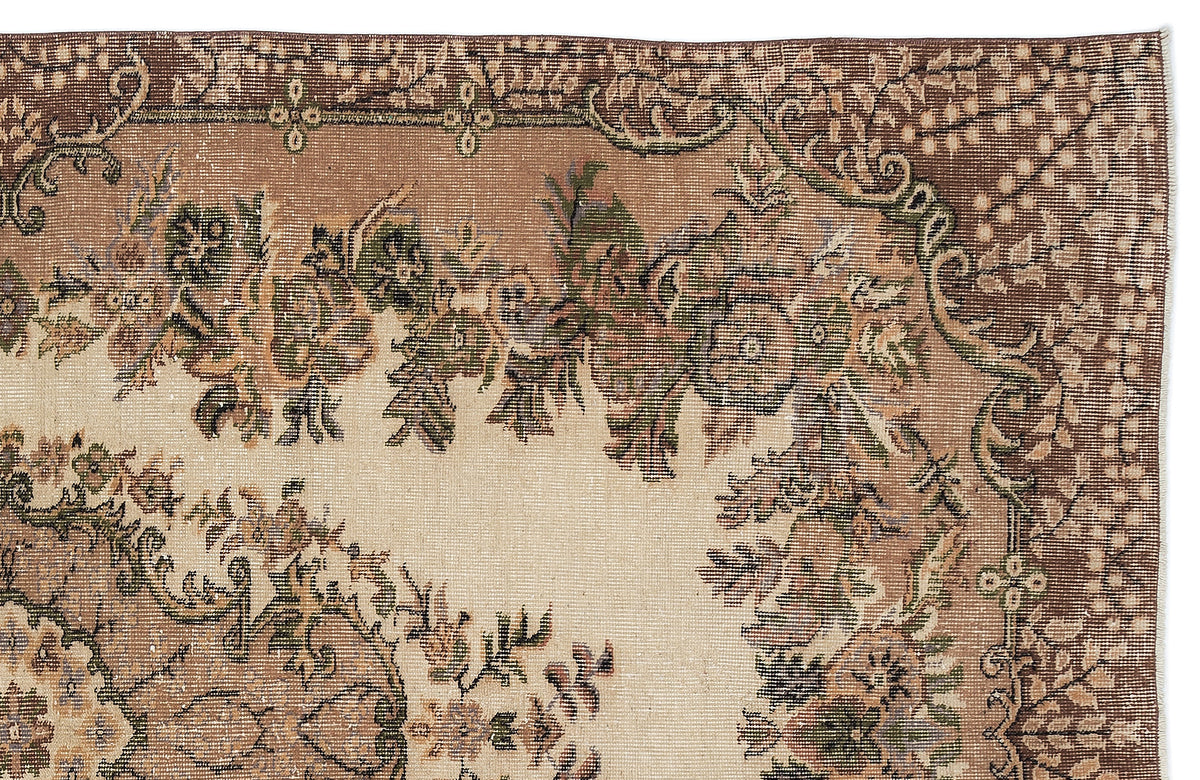 Beige and brown vintage-style rug with a detailed floral medallion pattern and a decorative border.