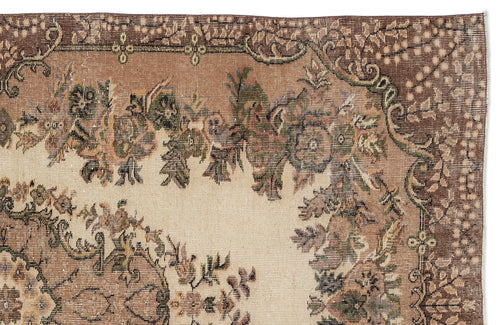 Load image 1 in gallery view. Beige and brown vintage-style rug with a detailed floral medallion pattern and a decorative border.
