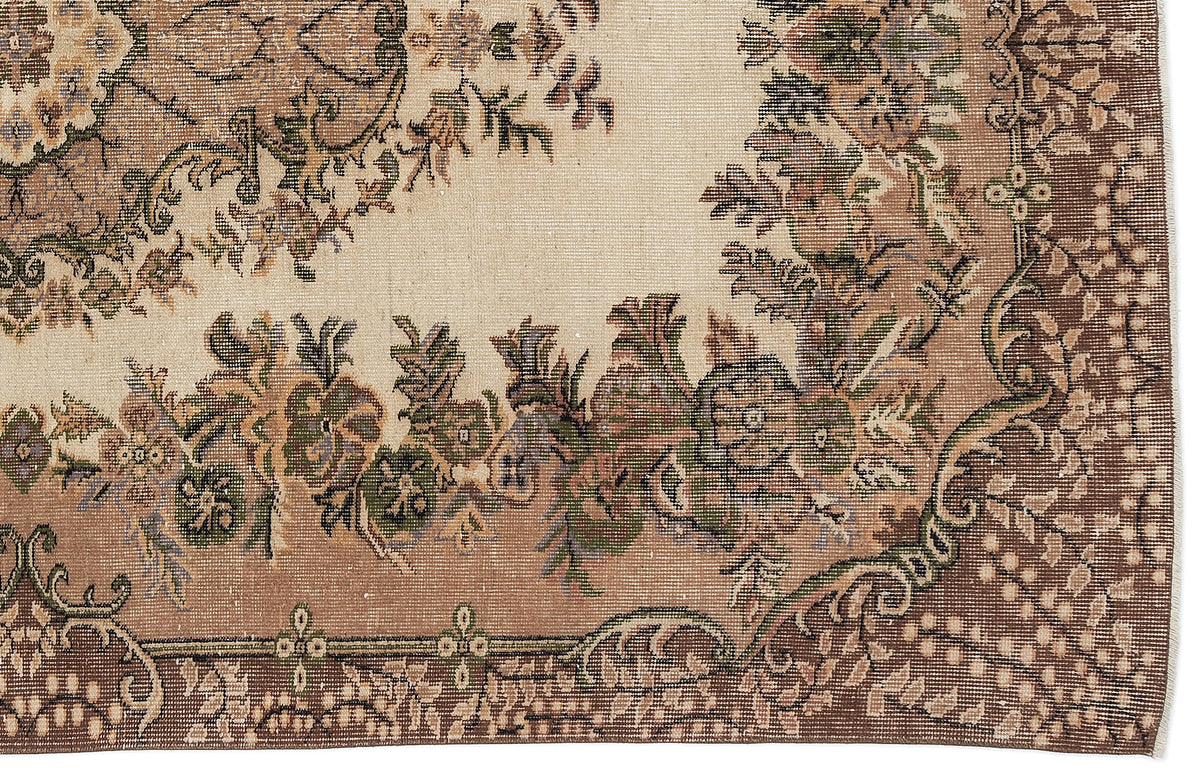 Beige and brown traditional rug with a floral medallion pattern and intricate decorative border.