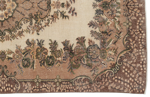 Load image 1 in gallery view. Beige and brown traditional rug with a floral medallion pattern and intricate decorative border.