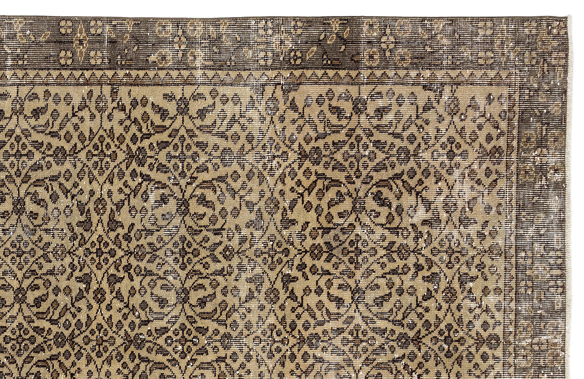 Tan and dark brown traditional rug with a distressed floral medallion pattern and a wide decorative border.