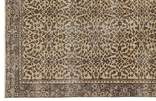 Load image 1 in gallery view. Tan and dark brown rug with a distressed, traditional floral vine pattern and a wide decorative border.