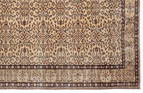 Load image 1 in gallery view. Tan and dark brown traditional rug with a distressed floral lattice pattern and a geometric border.