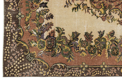 Load image 1 in gallery view. Distressed traditional rug with a beige center, brown border, and multi-colored floral medallion pattern.