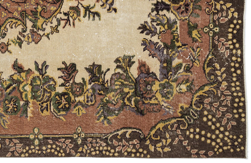 Load image 1 in gallery view. Distressed vintage-style rug with a cream center, brown border, and multicolored floral medallion pattern.