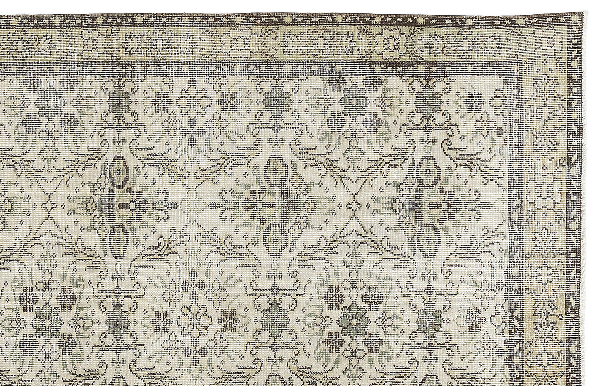 Beige and dark brown rug with a distressed traditional floral medallion pattern and a decorative border.