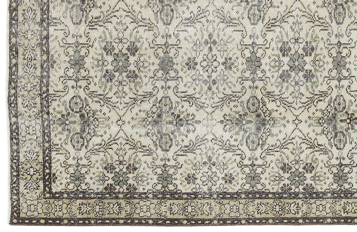 Beige and dark brown rug with a distressed traditional floral medallion pattern and a wide decorative border.