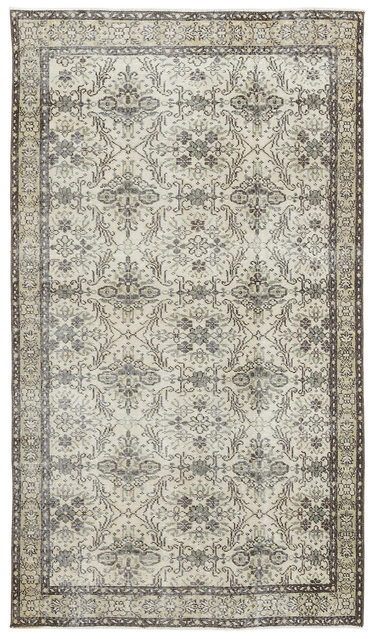 Distressed beige and charcoal rug with a traditional floral medallion pattern and a wide decorative border.