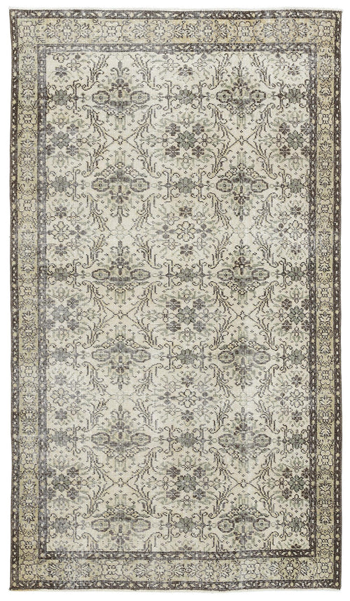 Load image 1 in gallery view. Distressed beige and charcoal rug with a traditional floral medallion pattern and a wide decorative border.