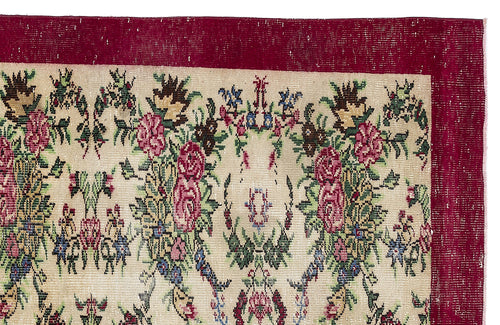 Load image 1 in gallery view. Beige rug with a deep red border and a multi-colored floral pattern featuring pink roses and green foliage.