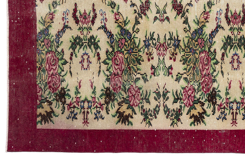 Load image 1 in gallery view. Beige rug with a floral pattern in red, green, and blue, featuring a wide solid red border.