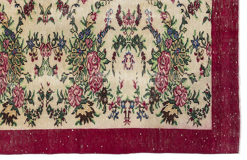 Load image 1 in gallery view. Beige rug with a floral medallion pattern in red, green, and blue, featuring a wide solid red border.