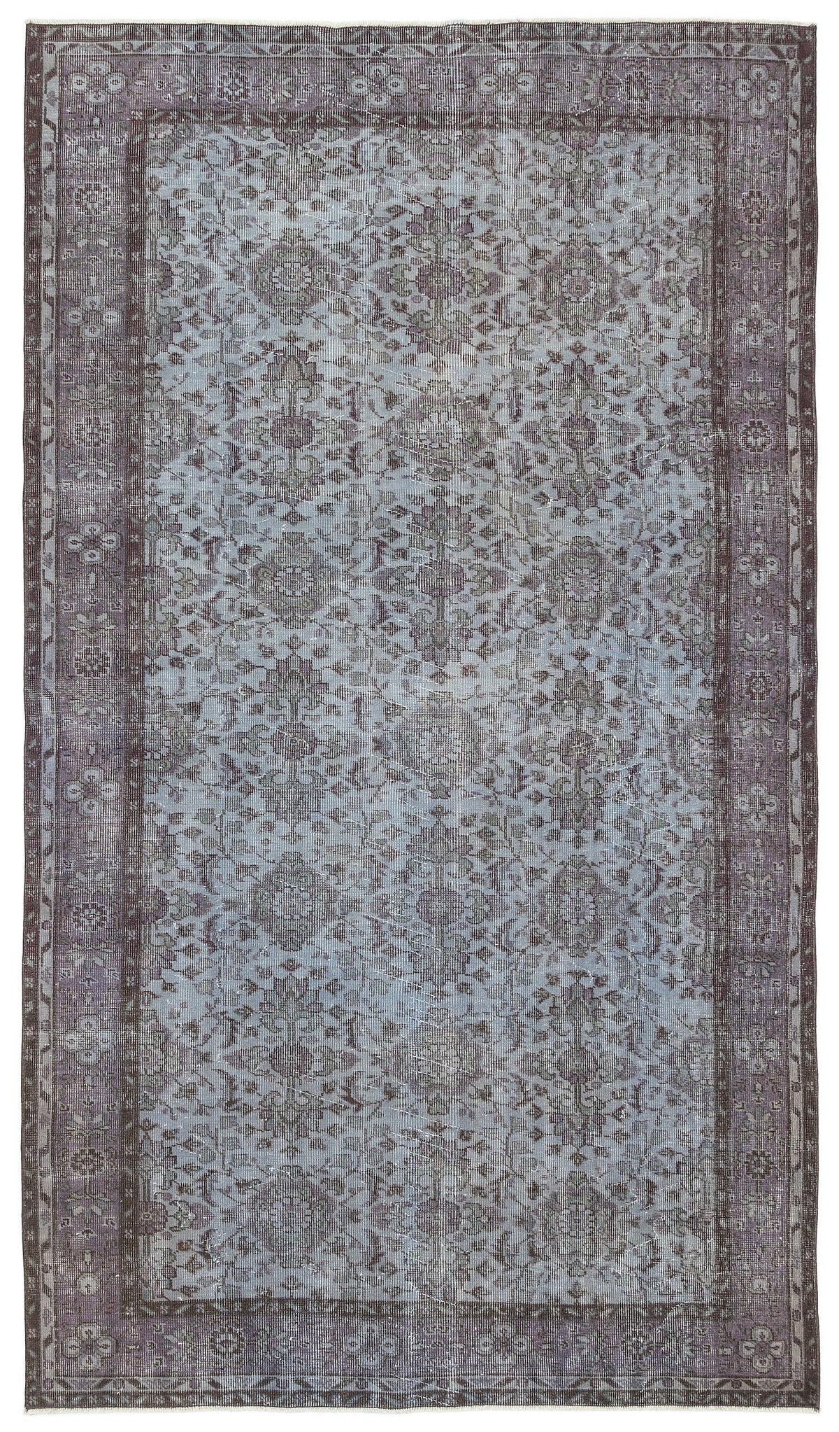 Muted blue and charcoal grey vintage-style rug with a distressed traditional floral medallion pattern and border.