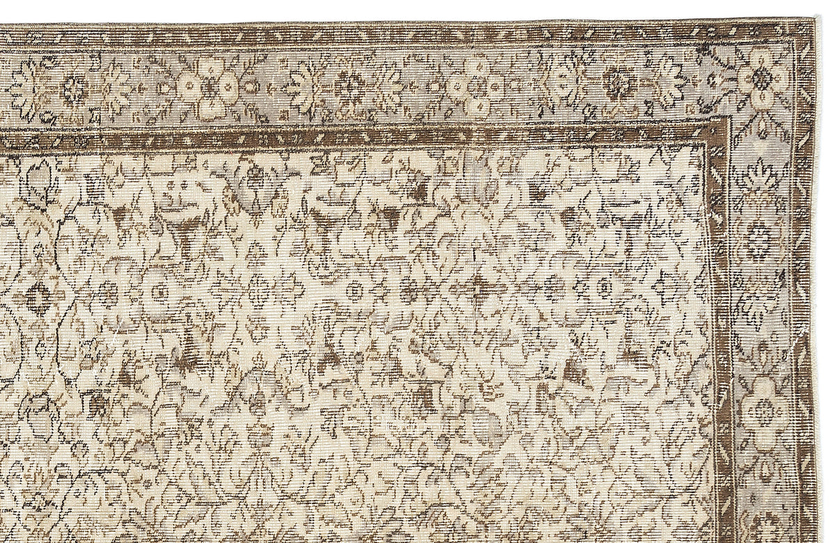 Beige and brown traditional rug with a distressed floral medallion pattern and a detailed border.