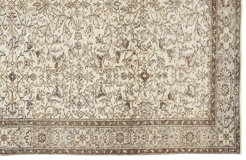 Load image 1 in gallery view. Beige and brown traditional rug with a distressed floral medallion pattern and a detailed border.