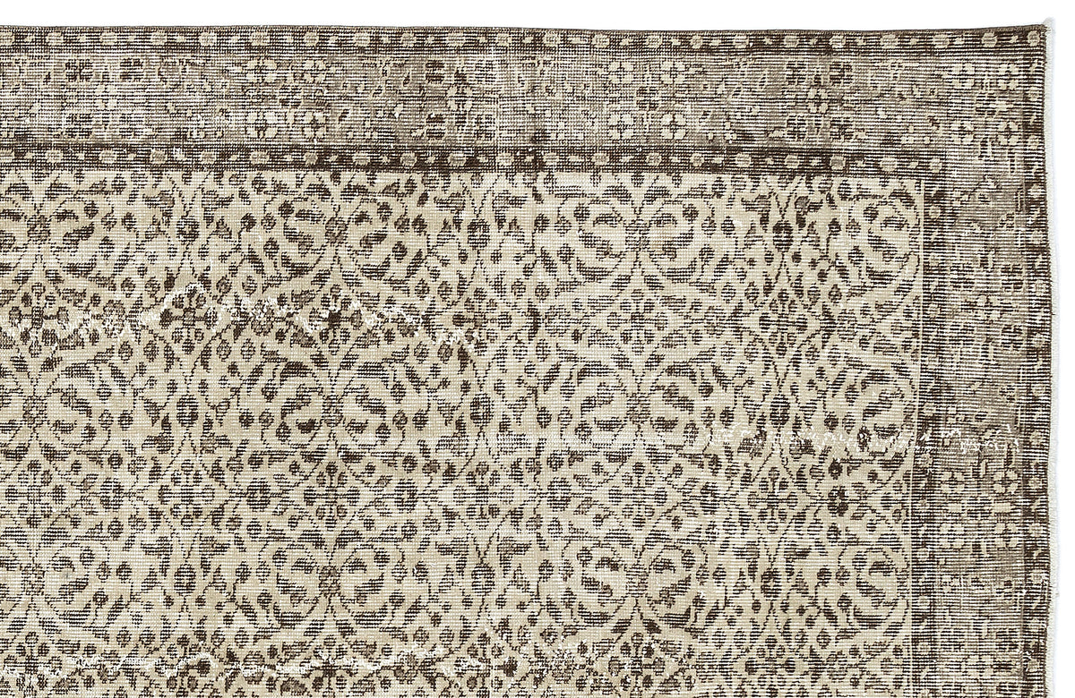 Brown and beige rug with a distressed, traditional floral medallion pattern and a wide decorative border.