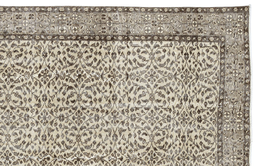 Load image 1 in gallery view. Brown and beige rug with a distressed, traditional floral medallion pattern and a wide decorative border.